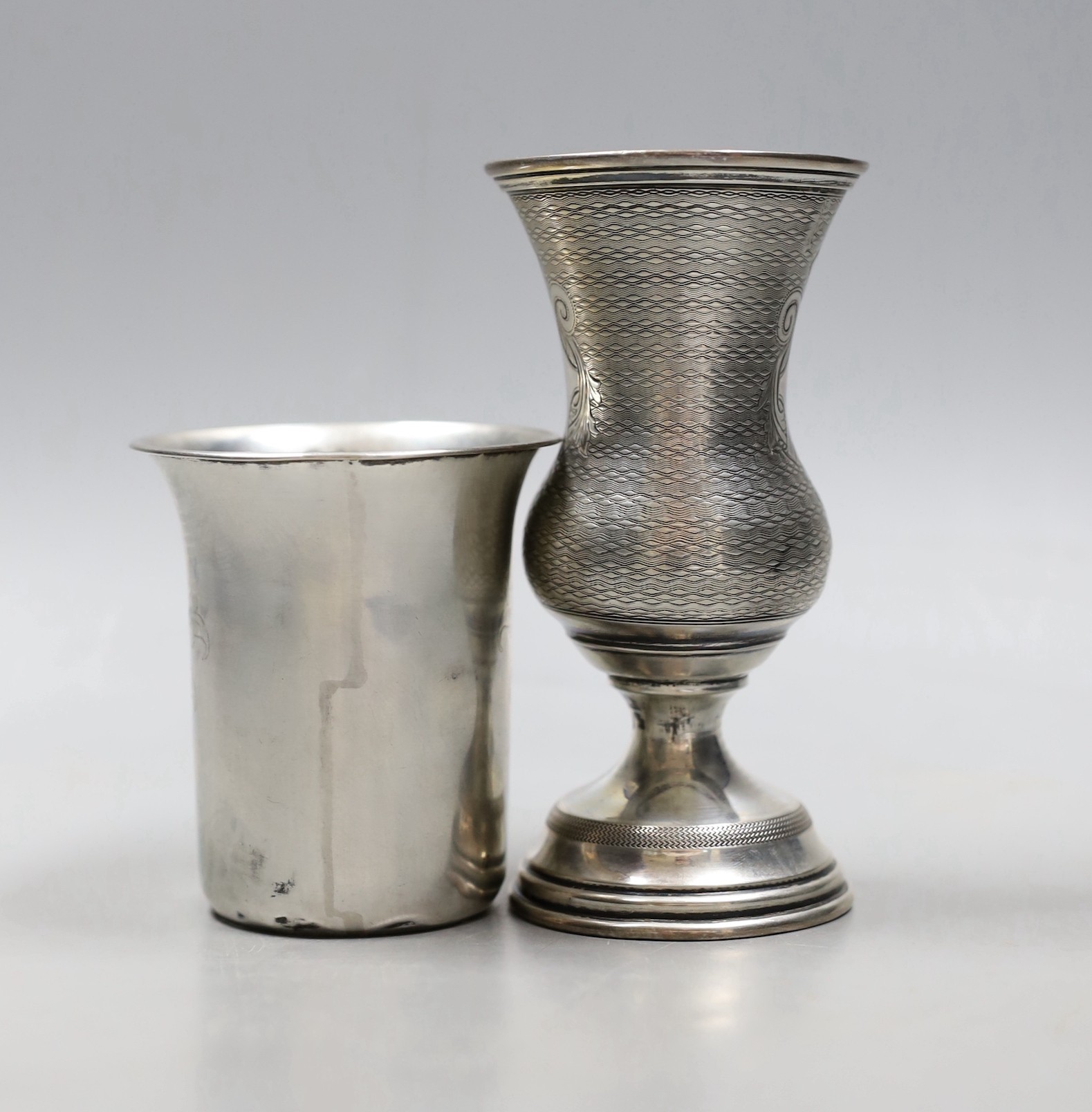 A late 19th/early 20th century Austro-Hungarian 800 standard white metal vase shaped cup, 12.6cm and a white metal beaker.